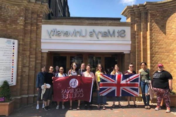 students with aquinas flag and british flag in front of St. Mary's University